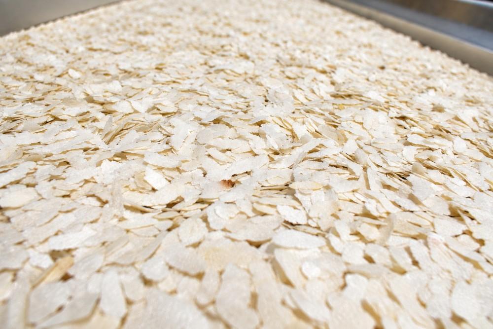 Rice Poha flakes on the production tray